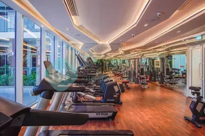 a gym with rows of treadmills and elliptical machines at Bloomfields Hidden Gem Studio In Arjan in Dubai
