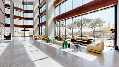 a lobby with couches and chairs in a building at The Community Jumeirah Village in Dubai