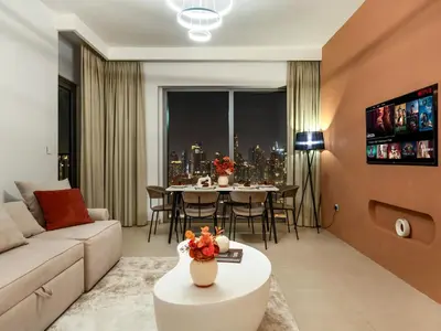 a living room with a couch and a table at Stunning Two-Bedroom Apartment with Skyline View & walk to Dubai Mall by TerraHome in Dubai