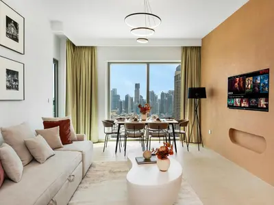 a living room with a couch and a table at Stunning Two-Bedroom Apartment with Skyline View & walk to Dubai Mall by TerraHome in Dubai