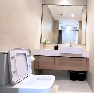 a bathroom with a sink and a toilet and a mirror at Farhad Azizi Residence - Al Jaddaf by Golden Casa in Dubai