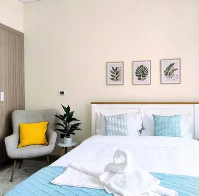 a bedroom with a bed with a swan towel on it at Farhad Azizi Residence - Al Jaddaf by Golden Casa in Dubai