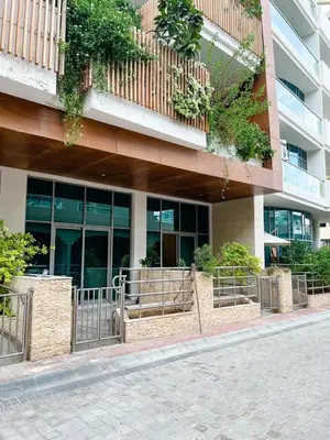 a building with a bunch of windows and plants at Beautiful studio apartment in Dubai