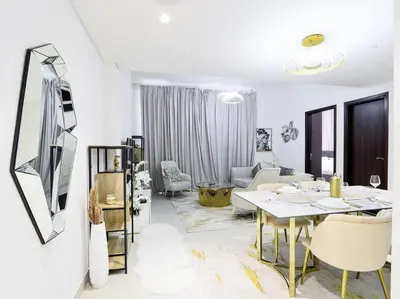 a white living room with a table and a couch at StoneTree - Fully Furnished - Dania 2 in Dubai