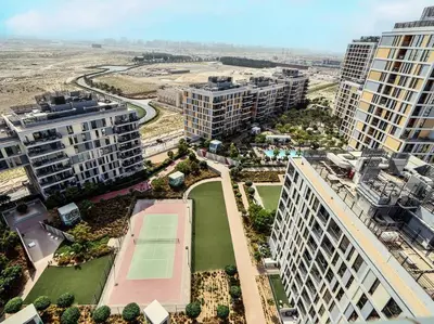 an aerial view of buildings with a tennis court at StoneTree - Fully Furnished - Dania 2 in Dubai