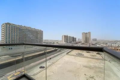 a view of a city from a balcony at StoneTree - Newly Furnished - Al Furjan in Dubai