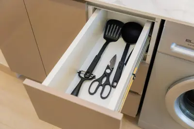 a drawer with utensils in a kitchen at Elite Escape - 1 BHK Getaway in Azizi Riviera in Dubai