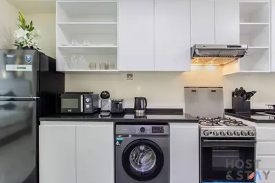 a kitchen with a washer and dryer on a counter at Calm and Cozy Studio in Loreto 1A, Damac Hills in Dubai