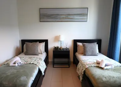 two beds in a room with two beds sidx sidx sidx sidx at Luminous 2 BR - Sobha Reserve in Dubai