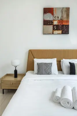 a bedroom with a white bed with towels on it at Peaceful Waterfront Marina View in Dubai