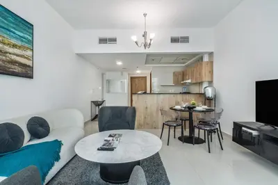 a living room with a couch and a table at Peaceful Waterfront Marina View in Dubai