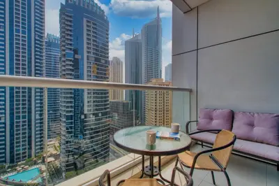 a balcony with a table and chairs and a couch at Peaceful Waterfront Marina View in Dubai