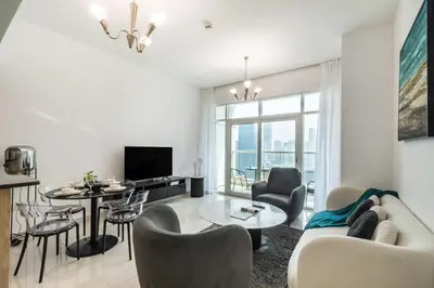 a living room with a couch and a table at Peaceful Waterfront Marina View in Dubai