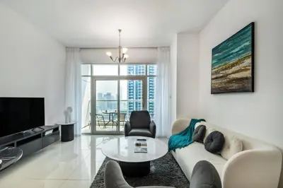 a living room with a couch and a table at Peaceful Waterfront Marina View in Dubai