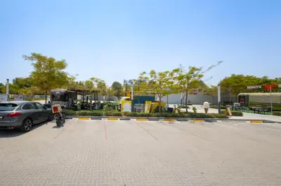 a parking lot with a car parked in it at Serenity Living - stunning 1BR, DAMAC Hills in Dubai