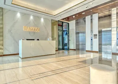 a lobby with a reception desk in a building at Chic and Cozy Studio in Dubai
