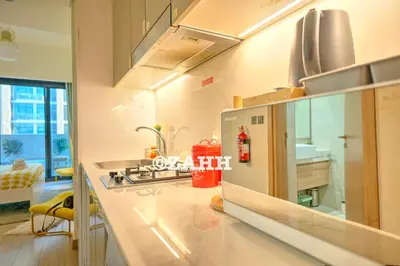 a kitchen with a sink and a stove top oven at Cozy Crib in Dubai