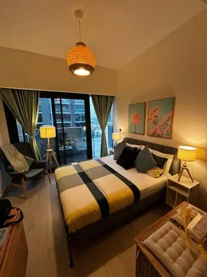 a bedroom with a bed and a large window at Heavenly Adobe in Dubai