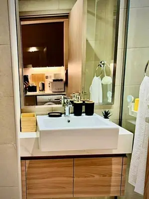 a bathroom with a white sink and a kitchen at Heavenly Adobe in Dubai