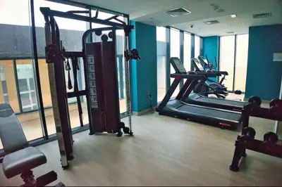 a gym with two tread machines in a room at Heavenly Adobe in Dubai