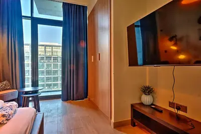 a room with a bed and a large window at Paradise Point in Dubai