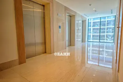 an empty hallway in a building with a glass door at Studio Haven in Dubai