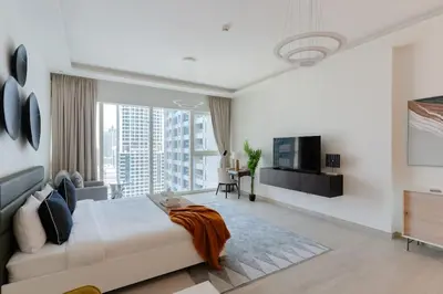 a bedroom with a large bed and a large window at New building l Near Metro l Spacious lay out in Dubai
