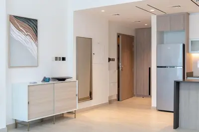 a kitchen with a counter and a refrigerator at New building l Near Metro l Spacious lay out in Dubai
