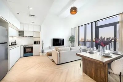 a living room with a couch and a table at Daniels 1BR at Creek Edge with Waterfront View in Dubai