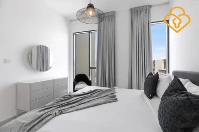 a bedroom with a large white bed and a mirror at Keysplease 4BR Villa walking to pool, Cherrywoods Family Community in Dubai