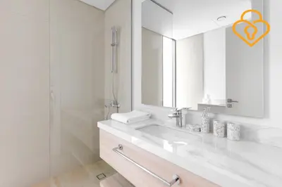 a white bathroom with a sink and a mirror at Keysplease 4BR Villa walking to pool, Cherrywoods Family Community in Dubai