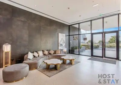 a living room with a couch and a table at Elegant 1BR Getaway in Bella Rose, Al Barsha in Dubai