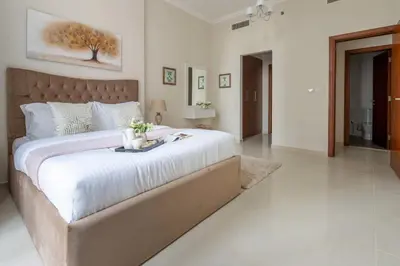 a large bedroom with a large bed with white sheets at Frank Porter - Dunya Tower in Dubai