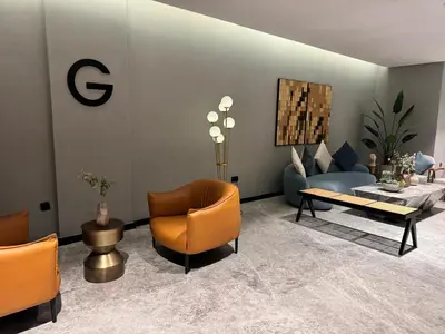 a living room with a couch and a table and chairs at 1 Bedroom with Canal View - 15 Northside in Dubai