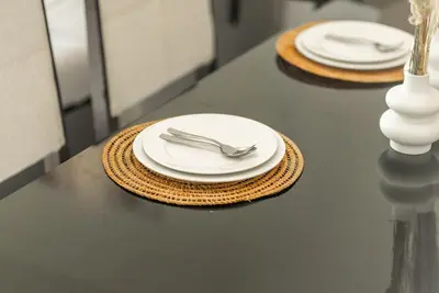 a table with two white plates and a fork and knife at Apartments in Address Dubai Marina Residences connected to Marina Mall in Dubai