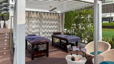 a patio with two massage tables on at Waves - Premium Seaside Retreat With Private Beach in Dubai