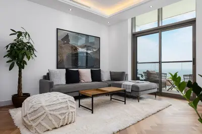 a living room with a couch and a table at Waves - Premium Seaside Retreat With Private Beach in Dubai
