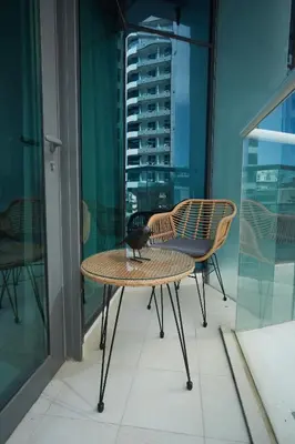 a bird sitting on a table on a balcony at Comfy stylish studio on the Palm in Dubai