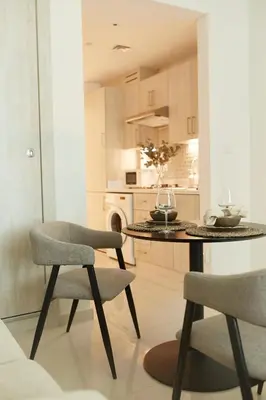 a kitchen with a table and two chairs at Comfy stylish studio on the Palm in Dubai