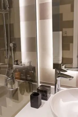 a bathroom with a sink and a mirror at Comfy stylish studio on the Palm in Dubai
