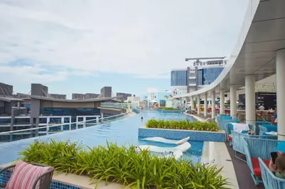 a pool on a cruise ship with people on it at Comfy stylish studio on the Palm in Dubai