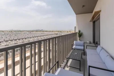a balcony with chairs and a view of a city at Bespoke Holiday Homes - Mag Eye Residence in Dubai