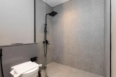a bathroom with a toilet and a shower at Bespoke Holiday Homes - Mag Eye Residence in Dubai