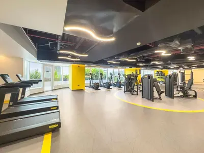 a gym with treadmills and machines in a room at Stylish 1 BR Apartment close to JBR Beach in Dubai