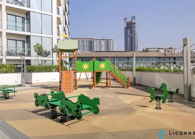 a playground with green play equipment on a building at Luxury One BR in Sobha Hartland in Dubai