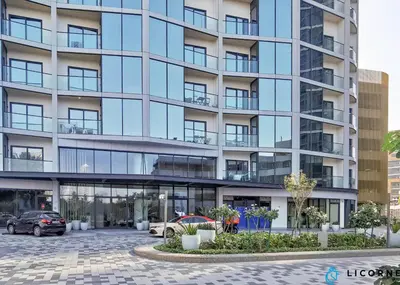 a large building with cars parked in front of it at Luxury One BR in Sobha Hartland in Dubai