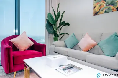 a living room with two chairs and a couch at Luxury One BR in Sobha Hartland in Dubai