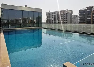 a large swimming pool on the roof of a building at Luxury One BR in Sobha Hartland in Dubai