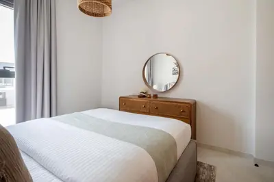 a bedroom with a bed and a mirror at Frank Porter - La Rosa 6 in Dubai
