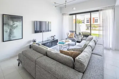 a living room with a couch and a tv at Frank Porter - La Rosa 6 in Dubai